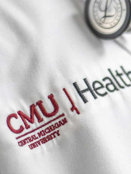 Person wearing a CMU Health lab coat and stethoscope.
