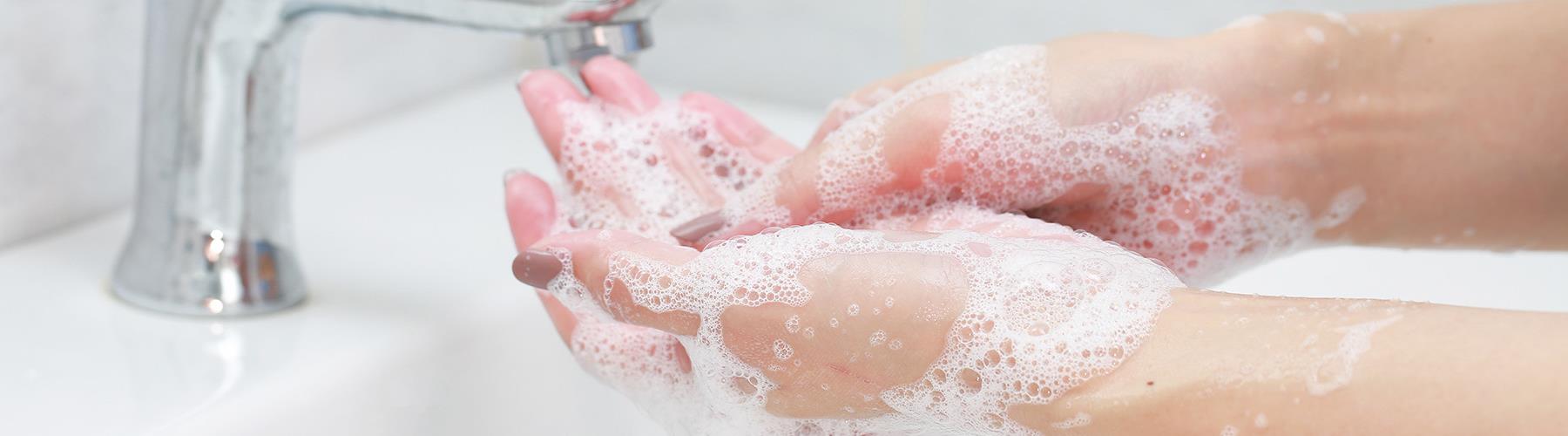 Hands covered with suds during hand washing.