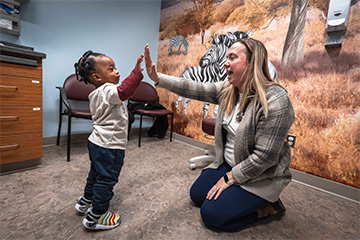 Nurse practitioner plays with child